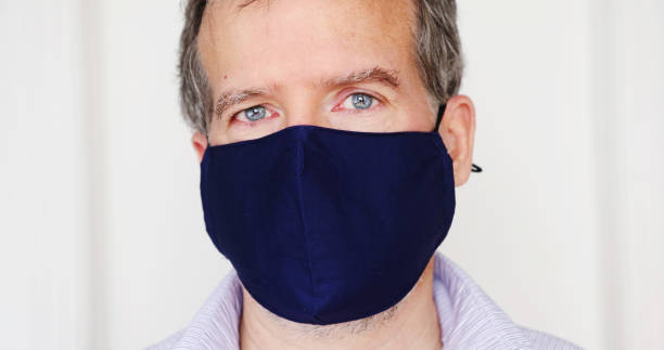 istock Serious mature man portrait behind protective mask 1292790739