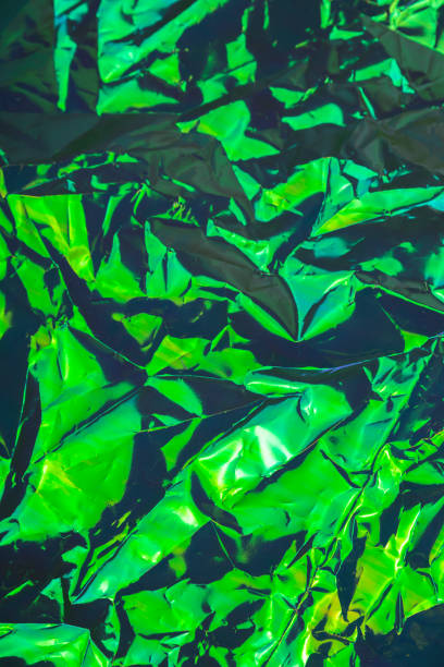 istock Green crumpled textured holographic trendy dark background 1292790862