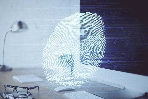 istock Computer on desktop in office with finger print drawing. Double exposure. Concept of business data security. 1292792621