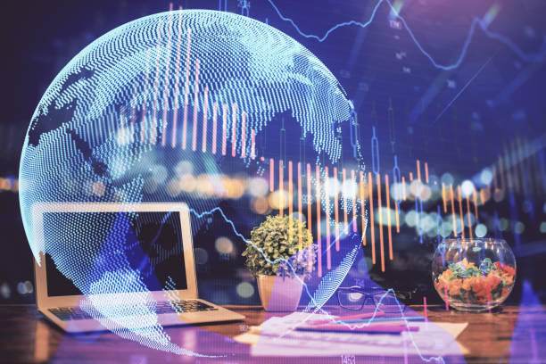 istock Forex graph hologram on table with computer background. Double exposure. Concept of financial markets. 1292792729