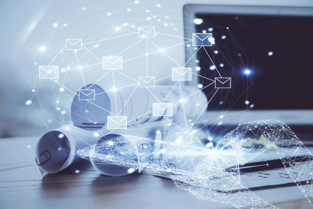 istock Desktop computer background in office and flying envelops hologram drawing. Multi exposure. Electronic mail concept. 1292792752