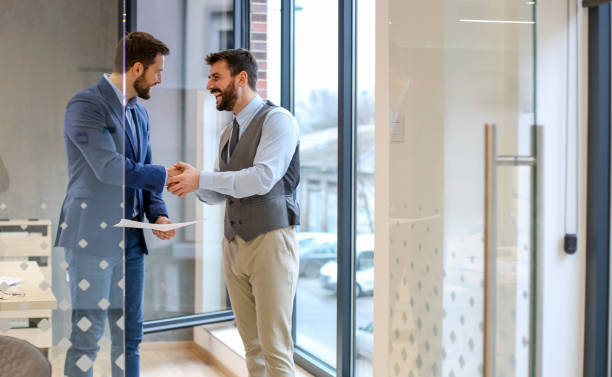 istock Young experts are sealing the deal with warm handshake. 1292792904