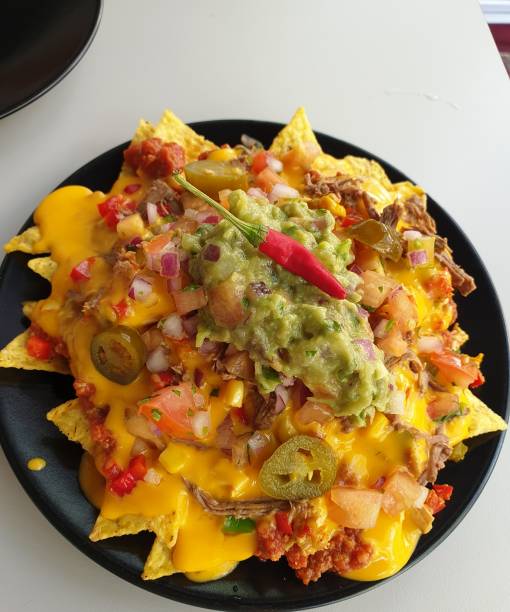 istock nachos with cheese and guacamoles with red chili pepper 1292795221