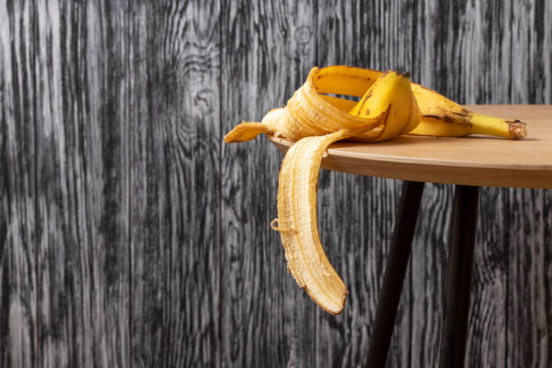 banana peel on a wooden table. - rotting banana vegetable fruit imagens e fotografias de stock