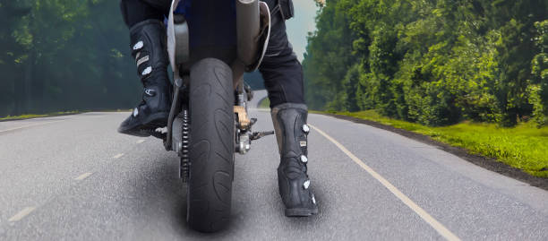 istock Motorcyclist on a country road. 1292799963