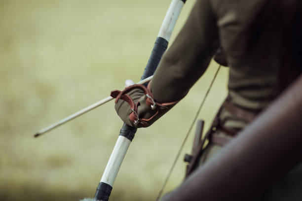 istock Young woman's hands with arrows and bow, close-up 1292801016