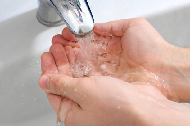 istock Wash hands with soap under the tap with water. Hygiene concept. 1292801176