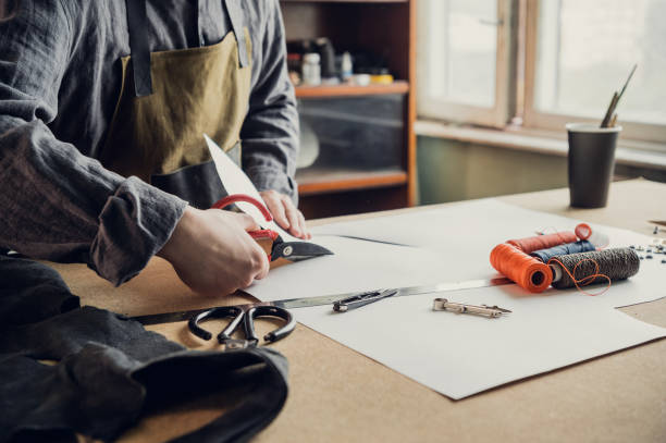 istock Before start working directly with the leather, the shoe manufacturer makes a preliminary pattern out of paper 1292802173