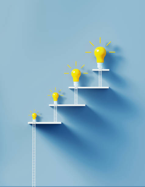 White Ladders Leaning on Two Lightbulbs over Blue Wall White ladders leaning on yellow lightbulbs to form a graph on over blue wall. Vertical composition with copy space. Creativity and solution concept. ladder photos stock pictures, royalty-free photos & images