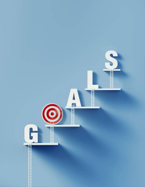 istock White Ladders Lean over A Bull's Eye Target and Write Goals on Blue Wall 1292806284