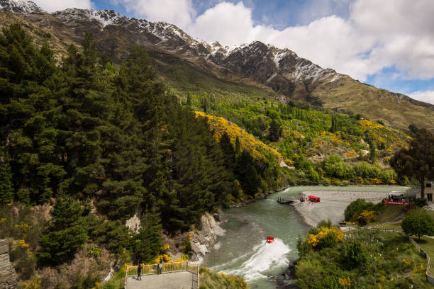 Jet Boat in Shotover River Queenstown, New Zealand - November 9, 2017: Jet boat making its way through the famous Shotover River in Queenstown one of the extreme activities that make it such a popular destination. jet boat stock pictures, royalty-free photos & images