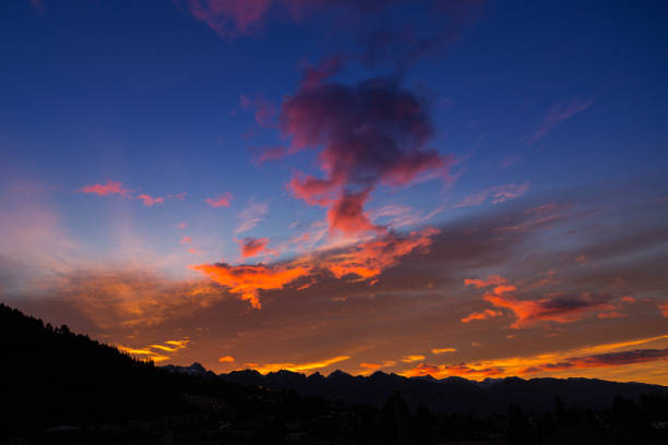 Queenstown, New Zealand - November 7, 2017: The colours of the sun setting over the mountains that surround the tourist hub of Queenstown, New Zealand