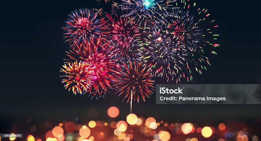 Abstract colored firework on dark sky. Celebration and anniversary concept Colorful firework with bokeh background. New Year celebration, Abstract holiday background Firework Display Stock Photo