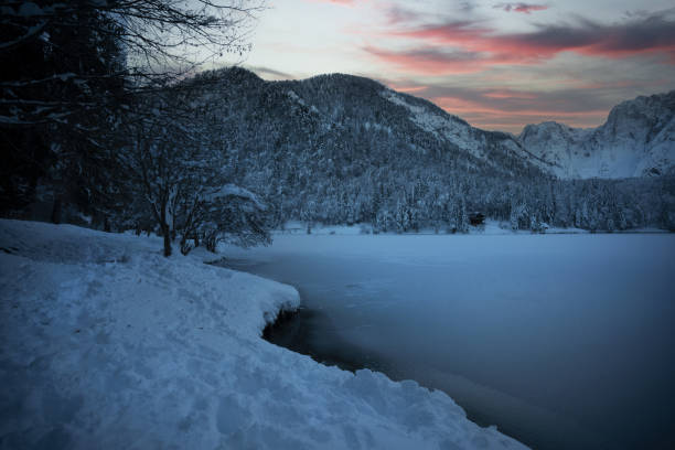 istock Fusine lake winter landscape 1292809676
