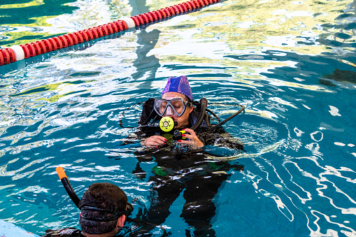 pair of divers in the water planning an activity