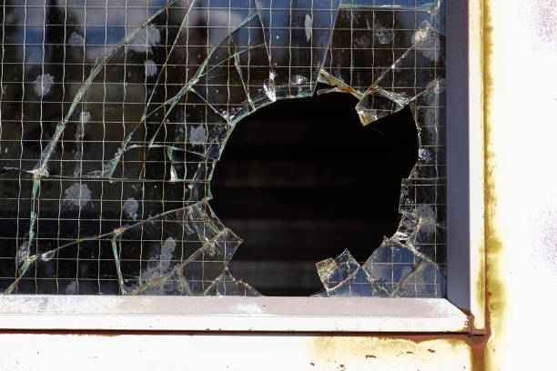 istock Closeup of a break-in through a wired glass window 1292812373