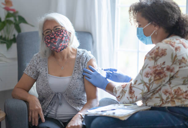istock Senior Filipino patient wearing face mask getting vaccination 1292813095