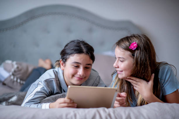 istock Sisters watching a movie on a tablet 1292813205