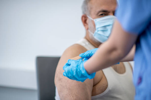 istock Putting band aid on after injection 1292813397