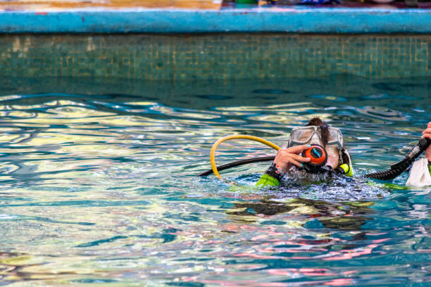 female diver surfacing with all her gear on