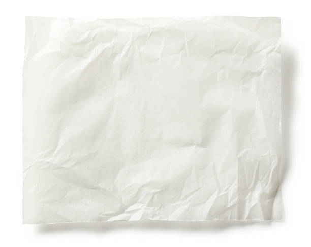 istock crumoled sheet of baking paper isolated on white background, top view 1292815559