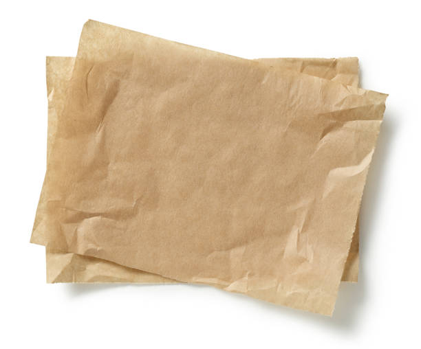 istock crumpled brown baking paper sheets isolated on white background, top view 1292815575