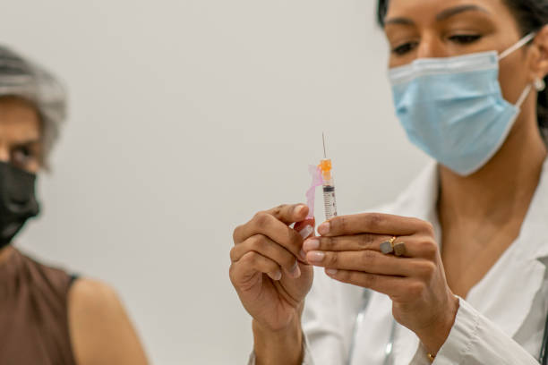 istock Doctor preparing COVID-19 vaccine 1292817453