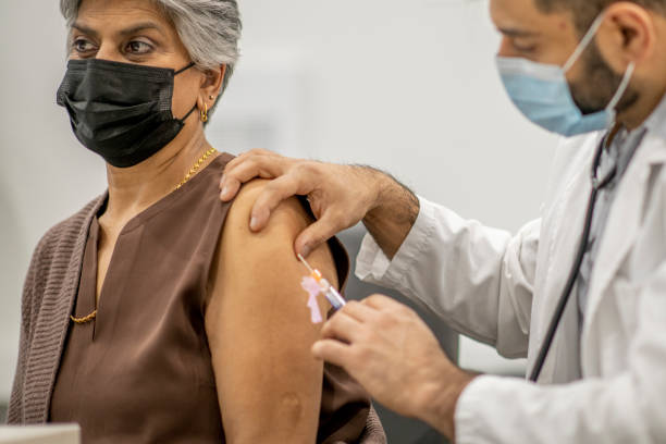 istock Senior woman getting COVID-19 vaccine 1292817467