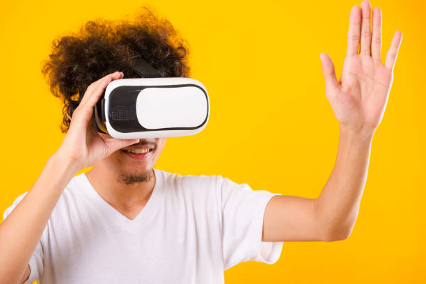 istock Asian handsome man with curly hair he using virtual reality headset or VR glass 1292817529