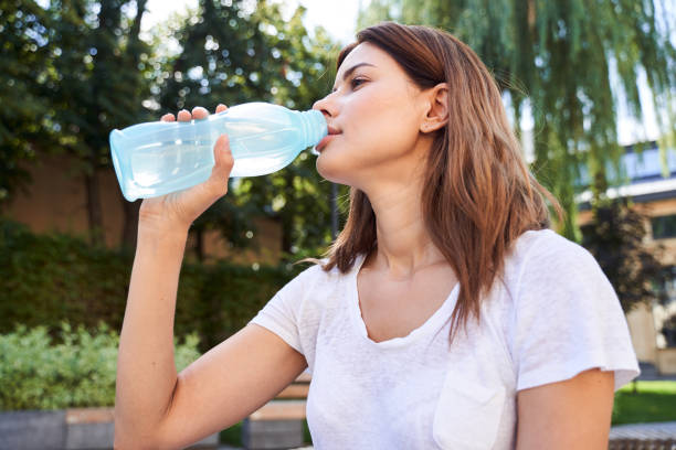 istock Girl drinking water after workout 1292817735