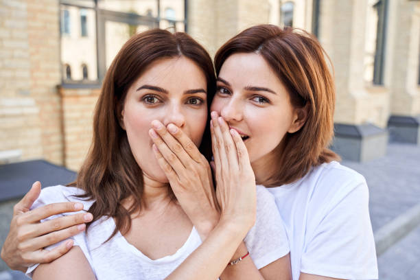 istock Girls closing mouths to each other 1292817752