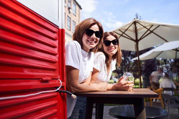 istock Students enjoying drinks at the summer street 1292822179