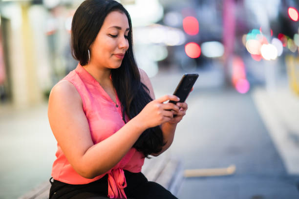 istock Smiling woman text messaging on smart phone. 1292825971