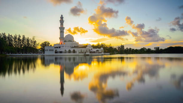 istock Mirror reflection of beautiful white floating mosque in a lake 1292828367