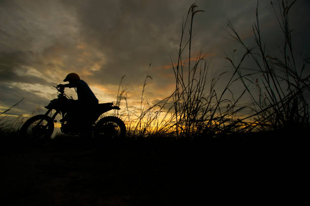 istock Silhouette of a man riding his motorcycle during sunset 1292830944