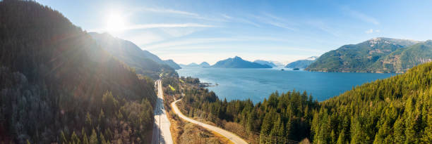 Aerial panoramic view of the Sea to Sky Highway Aerial panoramic view of the Sea to Sky Highway in Howe Sound, North of Vancouver, British Columbia, Canada. Taken during a sunny winter day. inlet photos stock pictures, royalty-free photos & images