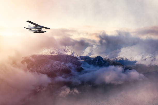 flugzeug fliegt in der nähe der beautiful canadian mountain nature landscap - propellerflugzeug stock-fotos und bilder