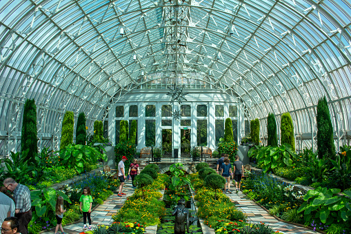 Saint Paul, Minnesota USA - September 2, 2017: Sunken garden in the Marjorie McNeely Conservatory at the Como Park Zoo and Conservatory. Built in 1915. U.S. National Register of Historic Places.