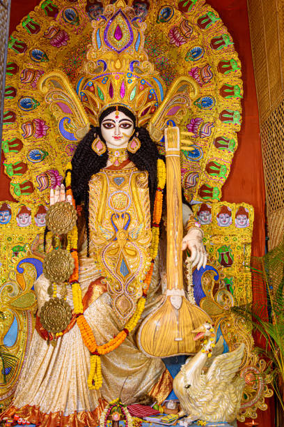 Goddess Saraswati idol decorated at Puja pandal, Saraswati symbolizes creative energy and is considered as the goddess of knowledge, music, art, wisdom, and learning. stock photo