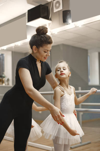 istock Child girls is studying ballet with teatcher 1292845392