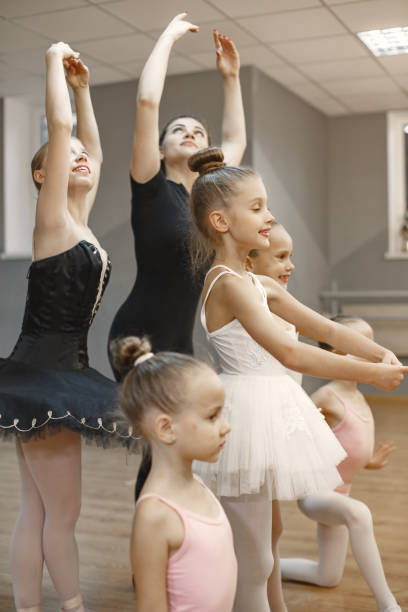 istock Child girls is studying ballet with teatcher 1292845893