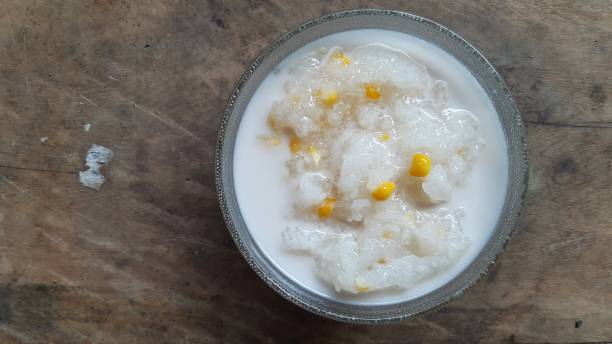 istock Sweet sticky rice with corn and coconut cream on wood table. 1292846932