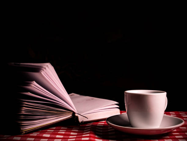 istock A coffee cup with a saucer and a notebook on the table. 1292853216