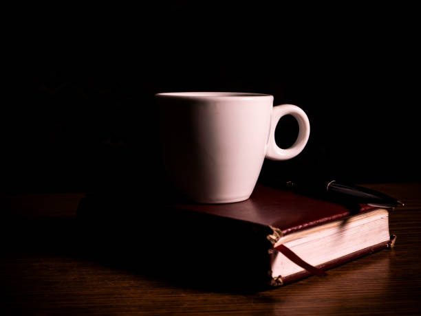 istock A coffee cup with a saucer and a notebook on the table. 1292853228