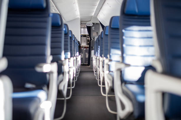 istock Empty dark blue passenger airplane seats in the cabin. 1292853522