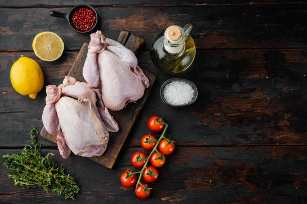 istock Fresh whole chicken carcass with ingredients, on old wooden table, top view with copy space for text 1292854217