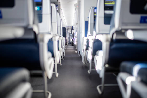 istock Empty dark blue passenger airplane seats in the cabin. 1292854359