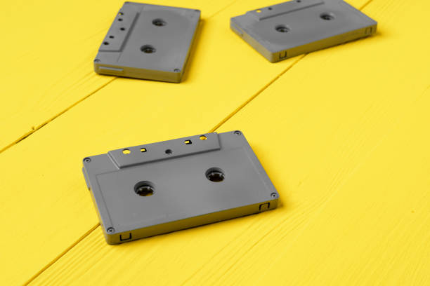 istock Gray audio cassettes on yellow background top view 1292856652