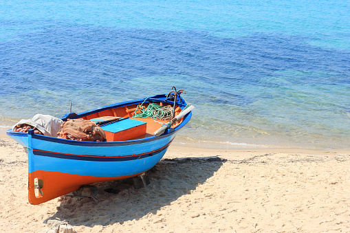 Fishing boat stranded on the beach in the Tunisian seaside resort of Hammamet.