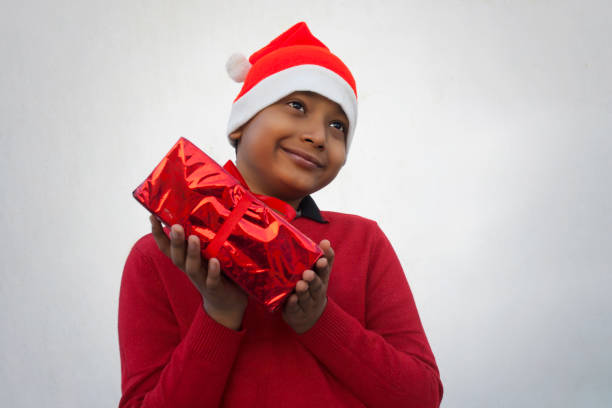 istock Happy young boy holding Christmas gift 1292856845